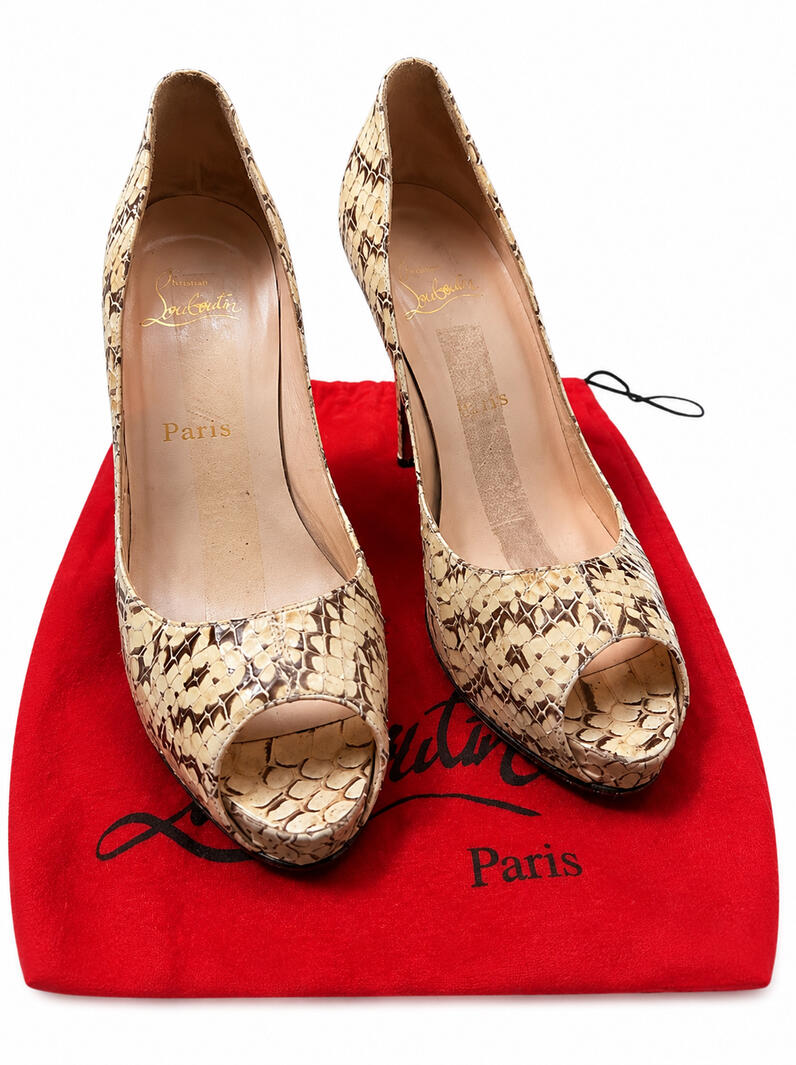 Authentic Christian Louboutin peep-toe pumps in natural beige and brown python snakeskin resting on a signature red branded dust bag.