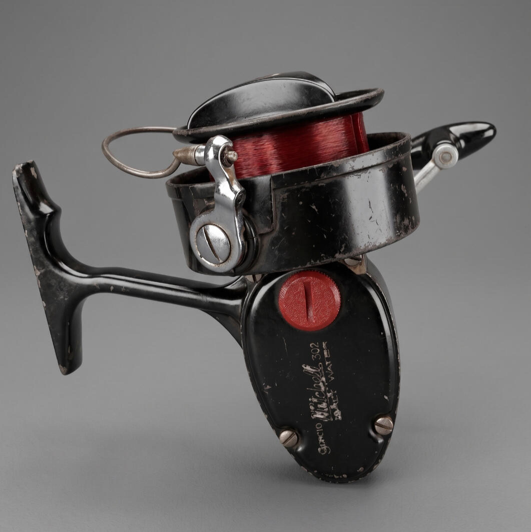 Vintage silver and black Garcia Mitchell 302 saltwater fishing reel in excellent condition.